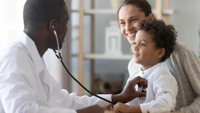 Doctor examining young child